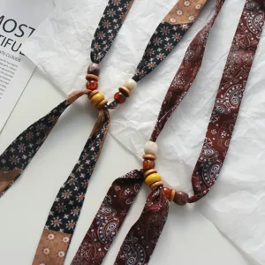 Boho floral fabric beaded scarf necklace with retro wooden charms for chic sweater styling.