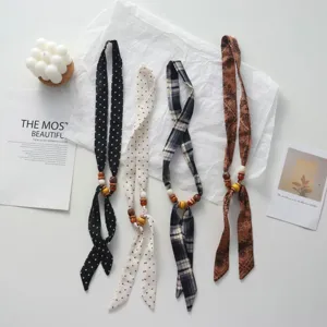 Polka dot beaded fabric scarf necklace for women, stylish adjustable sweater accessory.