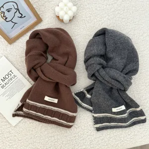 Detailed shot of cozy thick wool knit scarves in brown and dark gray with stylish stripes.