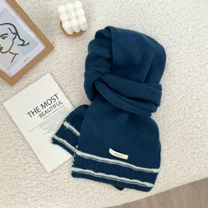 Cozy dark blue knitted scarf for women and men, winter warm wool-blend fashion accessory.