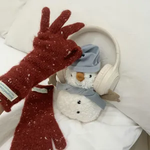 Red speckled knit gloves detail view, fingerless winter warm gloves with cute snowman prop.