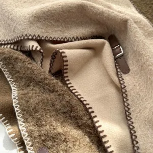 Écharpe châle tricotée en mélange de laine douce avec bord contrasté et boucle en cuir.