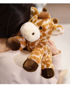 Detailed close-up of a soft giraffe plush toy resting comfortably on a warm knitted shoulder.