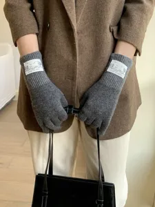 Grey knit gloves winter warm wool blend split finger gloves detail view and fabric texture