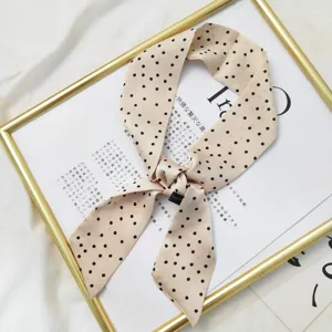 Silk skinny scarf with dense polka dots, elegant bow ribbon for stylish bags and neck wear.