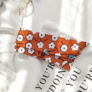 Gros plan détaillé du foulard en coton orange à motif floral classique de coquelicot élégant.