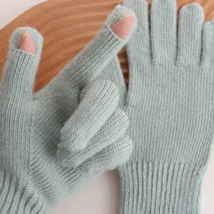 Vue détaillée de gants vert sauge sans doigts, montrant une texture côtelée et un design chaud.
