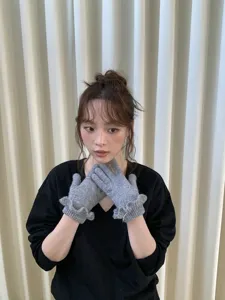 Grey knitted gloves with cute ruffle cuffs, warm winter accessories for women and students.