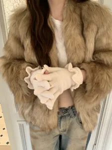 Detailed shot of women winter cute ruffles knit fingerless gloves, soft warm daily wear accessory.