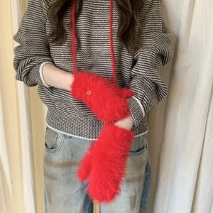 Red fuzzy winter gloves mittens detail view, soft plush hand warmers for cold weather style.