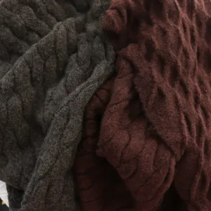 Chunky cable knit scarf detail, soft warm winter shawl fabric close up view, cozy style texture.