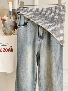 Fashion asymmetrical tweed waist denim jeans for women, trendy chic stacked design pants.