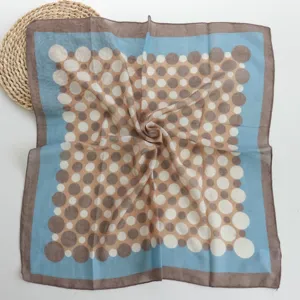 Cotton polka dot square scarf detail showing color block pattern and fine edge design.