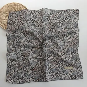 Close-up detail of lightweight paisley leopard print square scarf showing fine texture and pattern.
