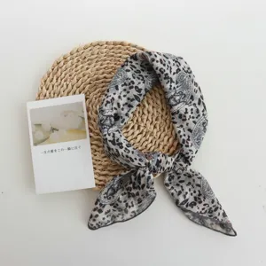 Detailed view of a trendy paisley leopard print small square scarf, lightweight and stylish.