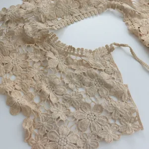 Close-up detail of beige floral crochet lace fake collar, elegant hollow out design.