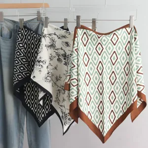 Detailed view of fashionable silk triangular scarves with geometric diamond and floral prints.