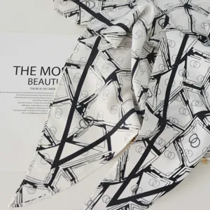 Detailed view of the black and white geometric pattern twill imitation silk triangle scarf.