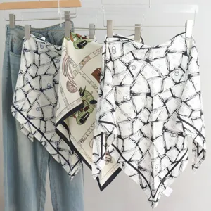 Close-up view of elegant silk triangular scarves hanging with classic chain and strap prints.