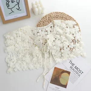 Detailed view of white crochet lace fake collar capelet, elegant floral hollow design for women.