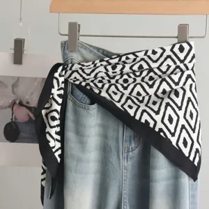 Stylish black and white geometric silk scarf waist belt accessory paired with denim waist.