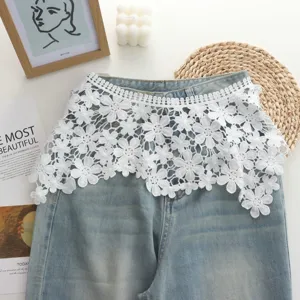 White floral lace waist extender skirt curtain detail view, stylish denim layering accessory.