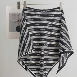 Black and white striped triangle scarf detail, soft twill silk neckerchief showing texture.