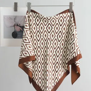 Detailed view of the stylish brown geometric print triangle silk scarf accessory.