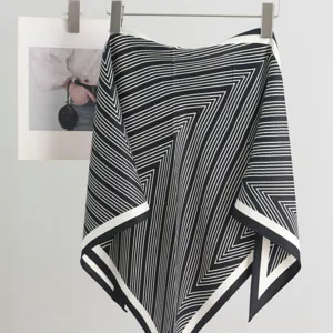 Close-up detail view of the black and white geometric scarf design perfect for women style.
