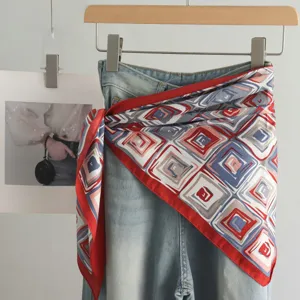 Korean style geometric printed silk scarf layered with denim jeans, fashionable waist accessory.