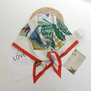 Elegant European style printed silk square scarf with vibrant red border and geometric design.