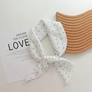 Detailed view of a French vintage polka dot cotton scarf, elegant small neckerchief accessory.