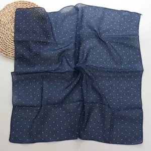 French vintage navy blue cotton square scarf with white polka dots, detailed close-up shot.