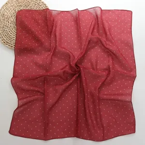 Detailed view of French vintage red polka dot square scarf, elegant cotton fabric neckerchief.