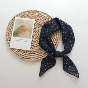 Detailed view of elegant black and white polka dot square scarf for women and girls.