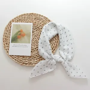 White small square scarf with geometric triangle pattern, chic neck scarf and stylish head wrap.