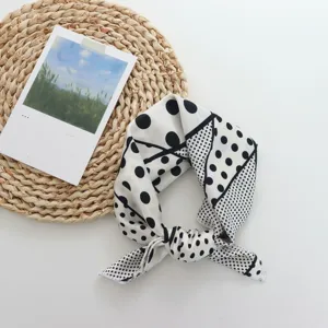 Silk small square scarf with geometric polka dot print, perfect for hair or neck styling.