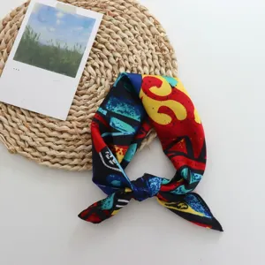Geometric print silk small square scarf detail view for hair tying and stylish shirt decoration.