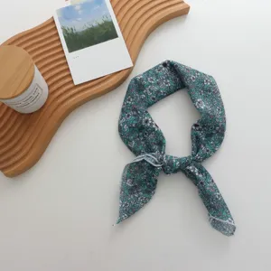 Floral cotton linen small square scarf detail shot showing delicate teal flower print and edge.