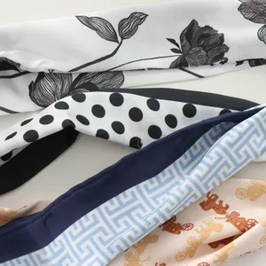 Detailed close-up view of stylish printed silk scarves with floral, polka dot, and carriage motifs.