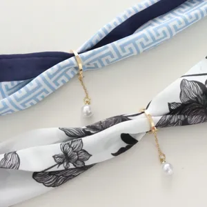 Silk scarf with magnetic buckle and pearl pendant detail, fashion accessory for women.