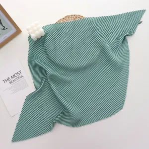 Detailed view of the solid color pleated square scarf showcasing fine texture and exquisite waves.