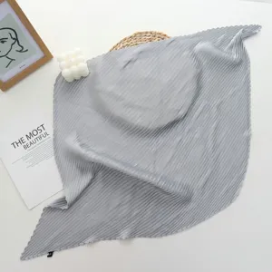 Detailed view of a grey pleated square silk scarf, elegant solid color neckerchief design.