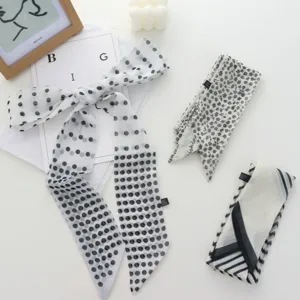 Elegant black and white polka dot and floral long silk scarf detail, chic hair ribbon accessory.