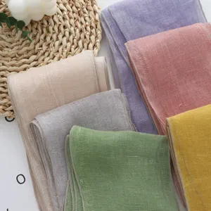 Detailed view of colorful lightweight linen scarves, soft textured fabric with neat edges.
