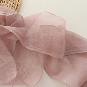 Pink linen long ribbon scarf detail close-up, elegant solid color neck wrap accessory.
