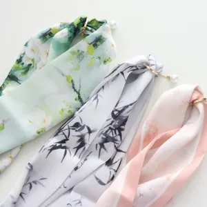 Detailed view of long silk scarf featuring floral print and pearl magnetic buckle.