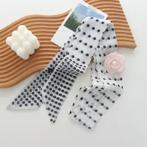 Detail view of retro polka dot long twilly silk scarf featuring cute pink rose decor.