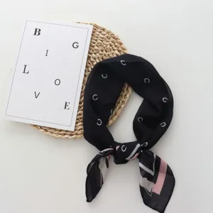 Detailed view of the chic black vintage style square scarf with letter print and elegant border.