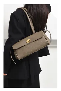 Retro taupe quilted baguette shoulder bag with elegant metal clasp and long strap for women.